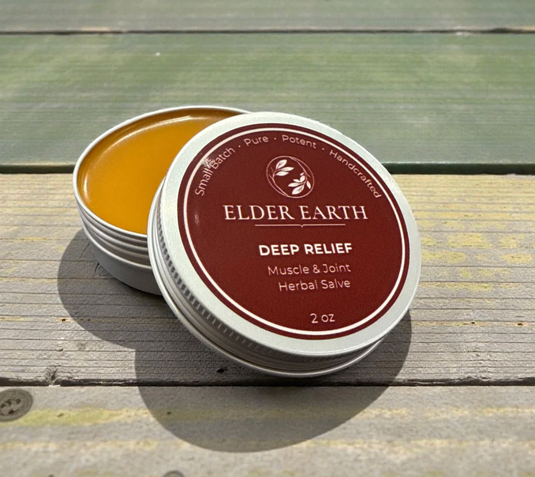 Deep Relief muscle and joint herbal salve in a 2oz tin on a wooden background